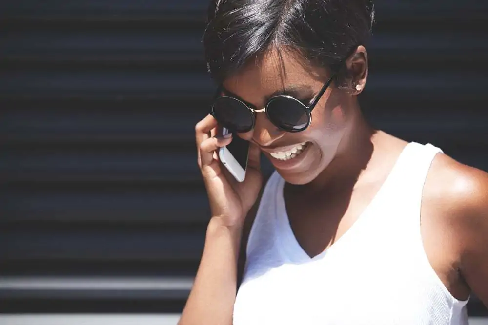 Black women on the phone asking do hair straighteners really cause hair damage