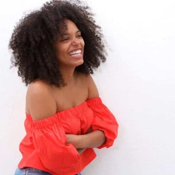 A black girl uses a scalp massage device for increased hair thickness and to reduce hair loss.