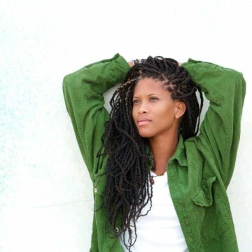 black women wearing goddess braids locs and green shirt