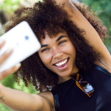 A light-skinned black lady with dry hair used a few drops of warm grapeseed oil to promote healthy hair growth.