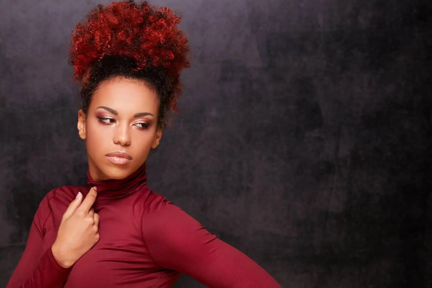 Black girl with curly long hair that's a dark brown natural color after being dyed with permanent hair color.