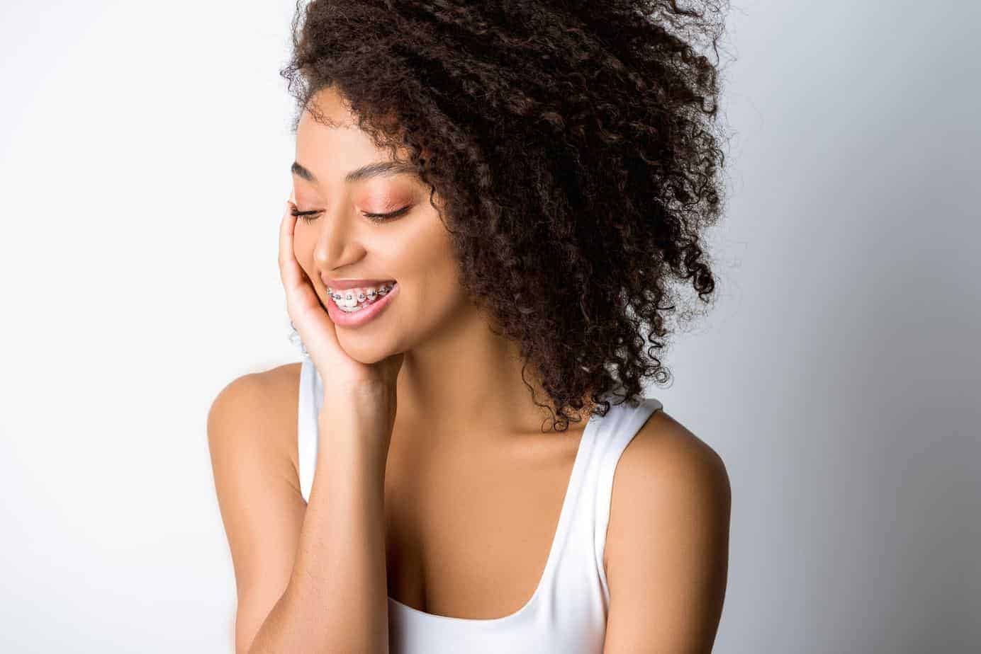 African American female admiring her hair after using rosemary oil