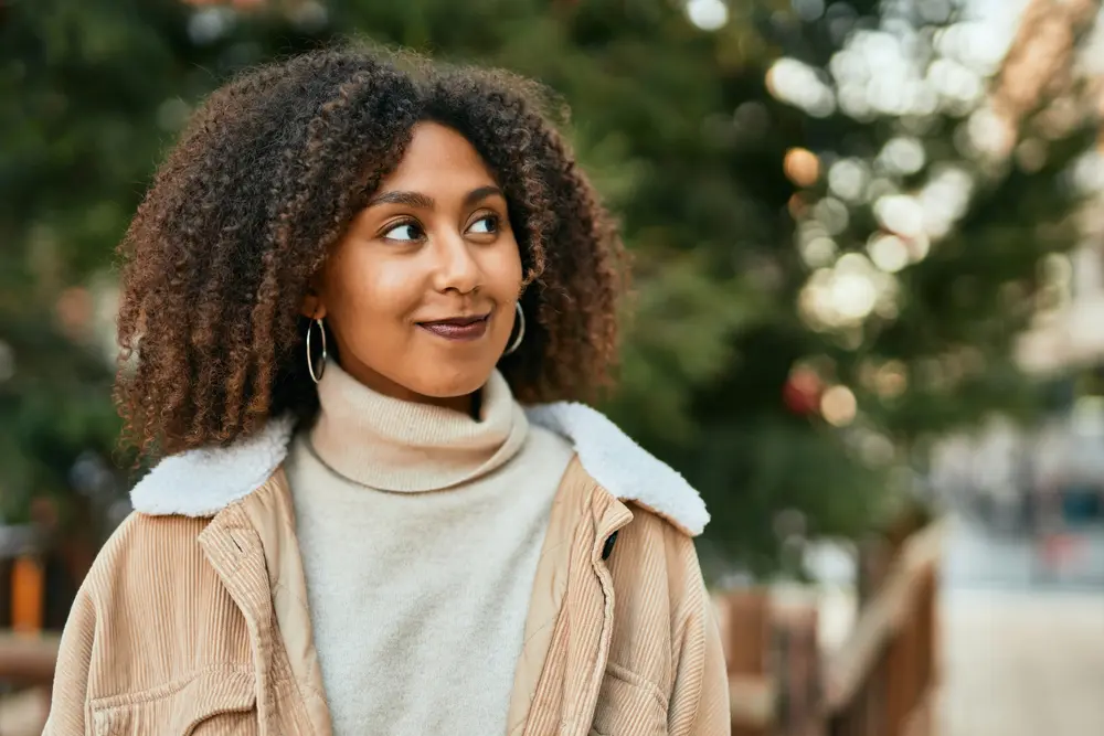 Young African American woman smiling happy standing at the park.