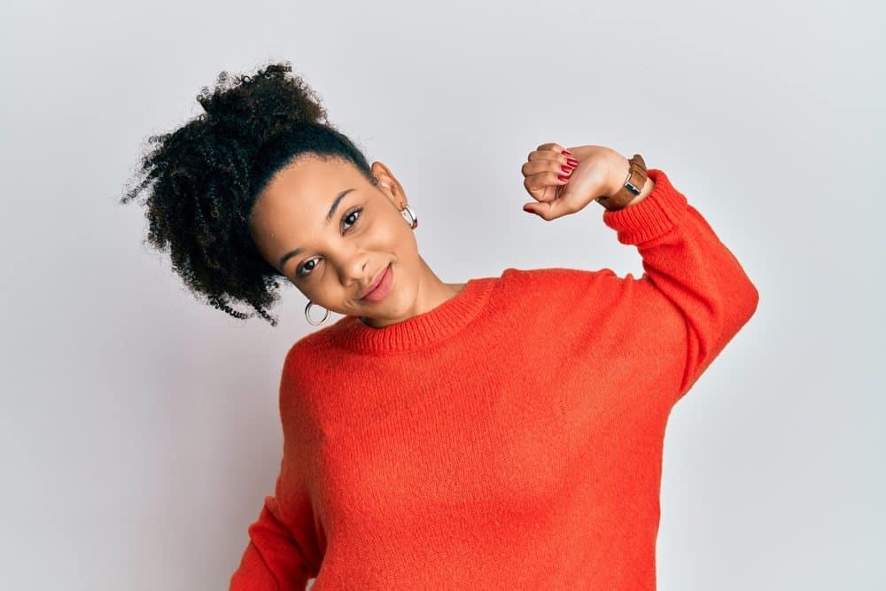 Young african american girl wearing casual clothes stretching her arms, after waking up tired and still sleepy, yawning for early morning.