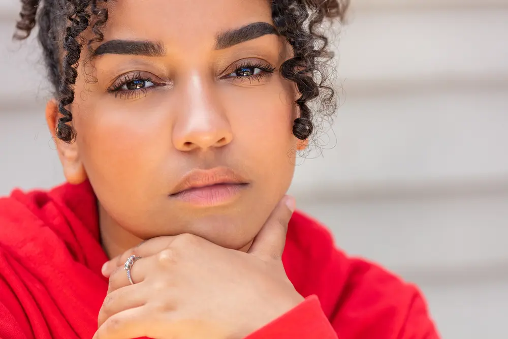 Portrait of a thoughtful black mixed race African American female young outside.