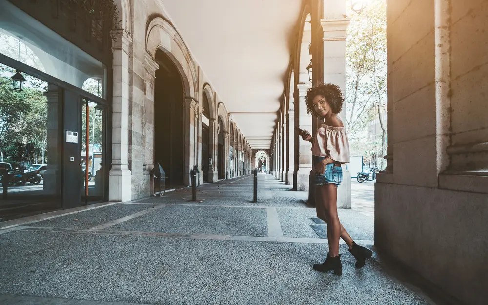 A wide-angle shot of a beautiful young African-American female with type 3a curly hair.