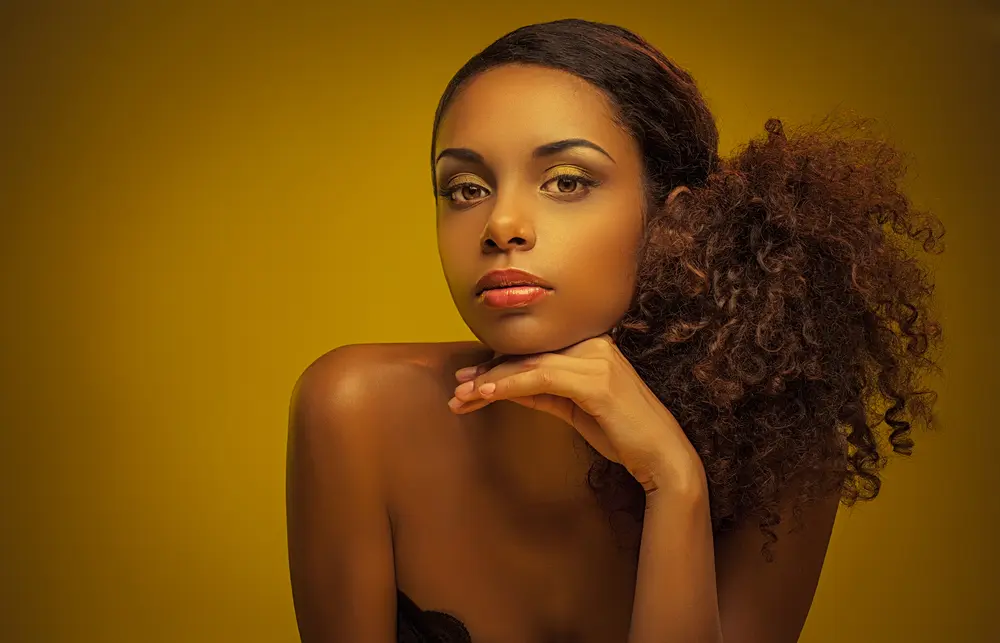 Portrait of a beautiful young African woman wearing a naturally curly ponytail.