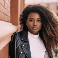 African American female with naturally curly hair styled with thyme oil