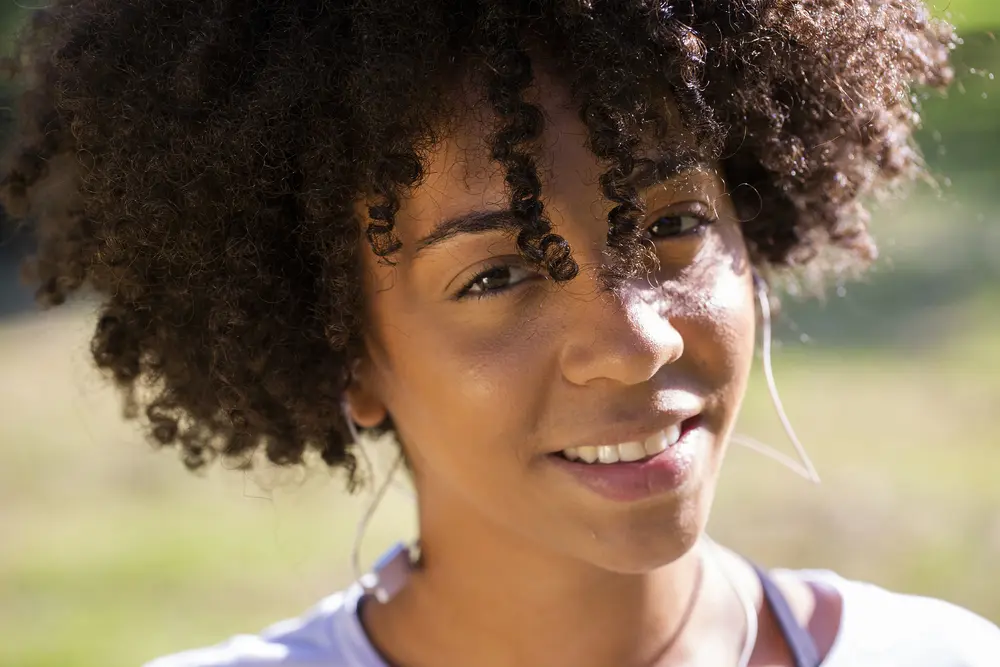 Close up portrait of an attractive Brazilian woman smiling outdoors.