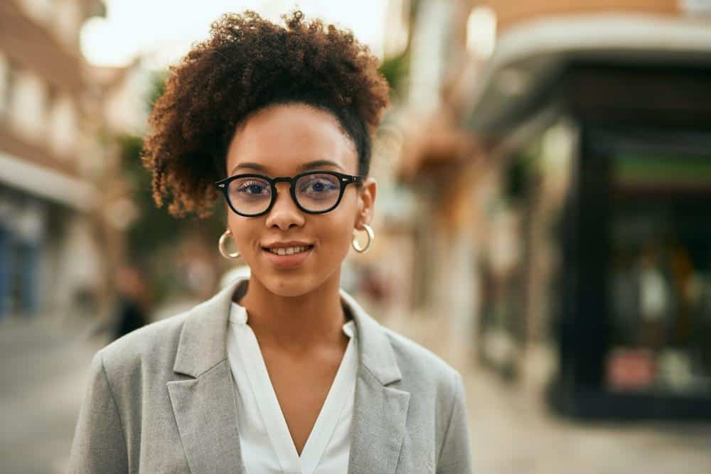 Young African American businesswoman wondering if peppermint oil is good for her hair.