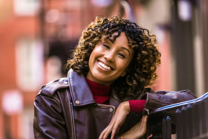 African American female with a sweet smile and 4b curls