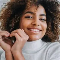 young black girl learning how to detangle natural hair with aloe vera