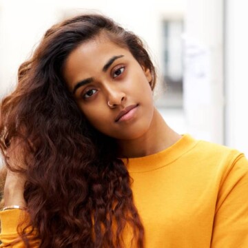 A beautiful dark-skin female leaving a hair appointment with freshly washed hair during a particularly hectic week.