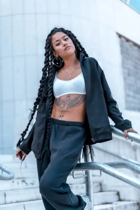 Mixed race girl with a type 2a curl pattern wearing Brazilian virgin hairpieces in long braids