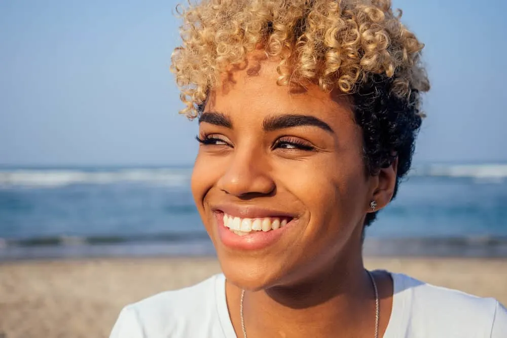 Afro-Latin American woman with perfect skin soaking up the UV rays while she enjoys the beach