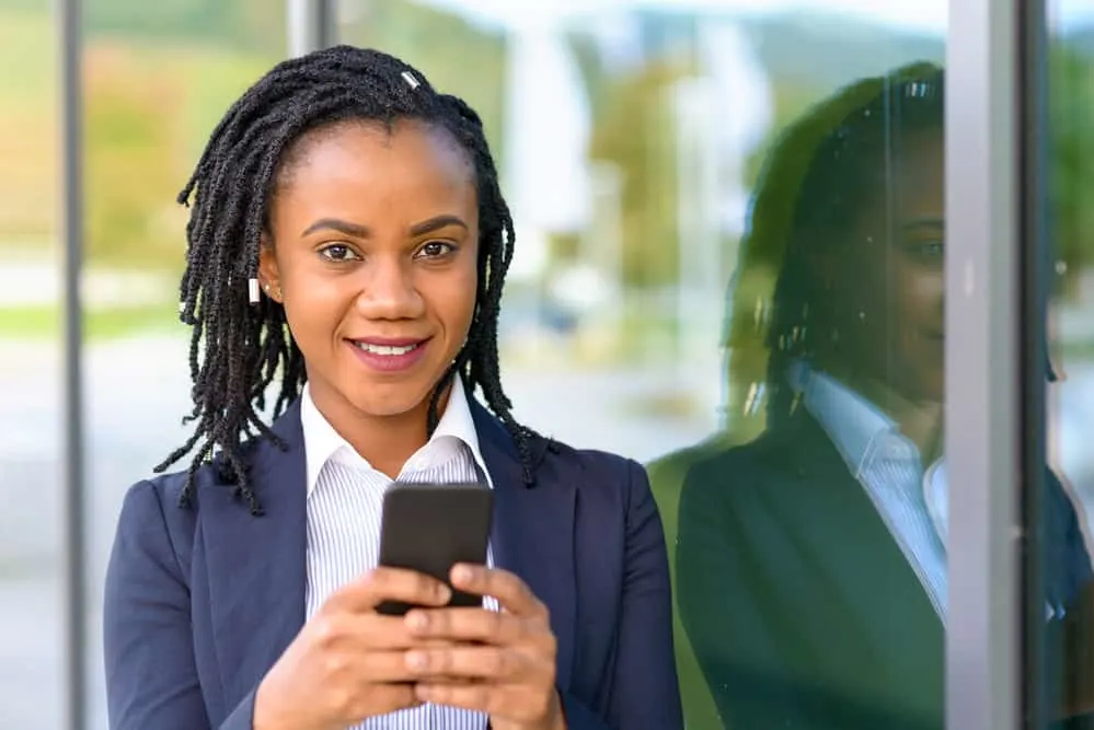 African American girl with budding phase locs started with two-strand twists wearing a business suit