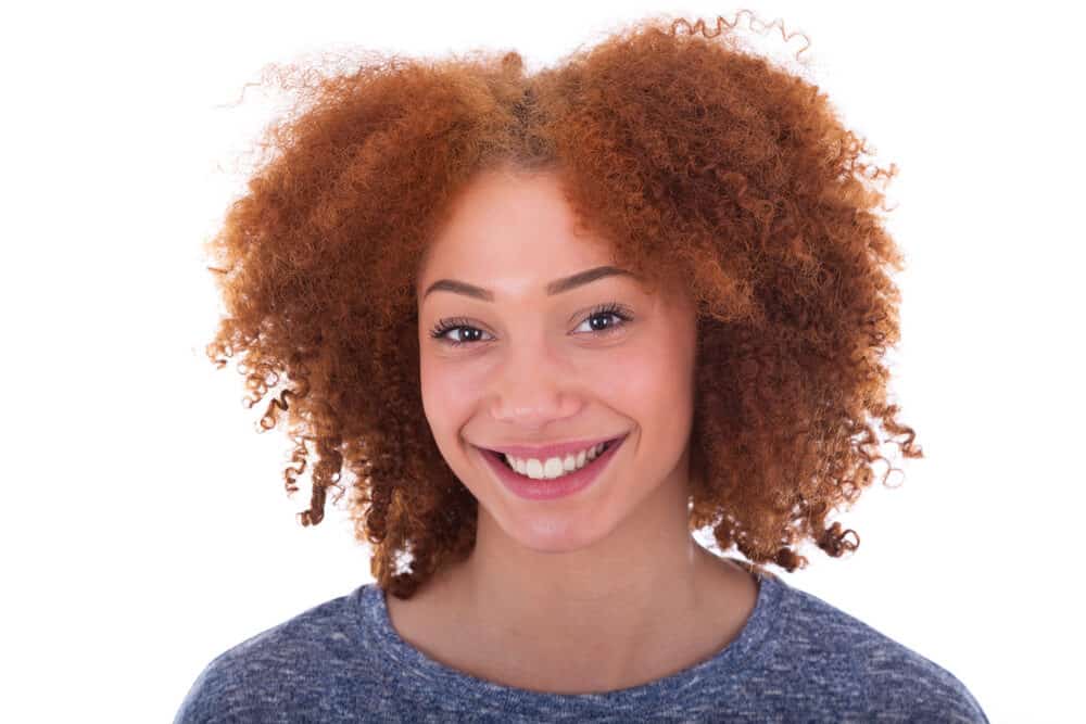 Young African American lady with pale skin and natural red hair