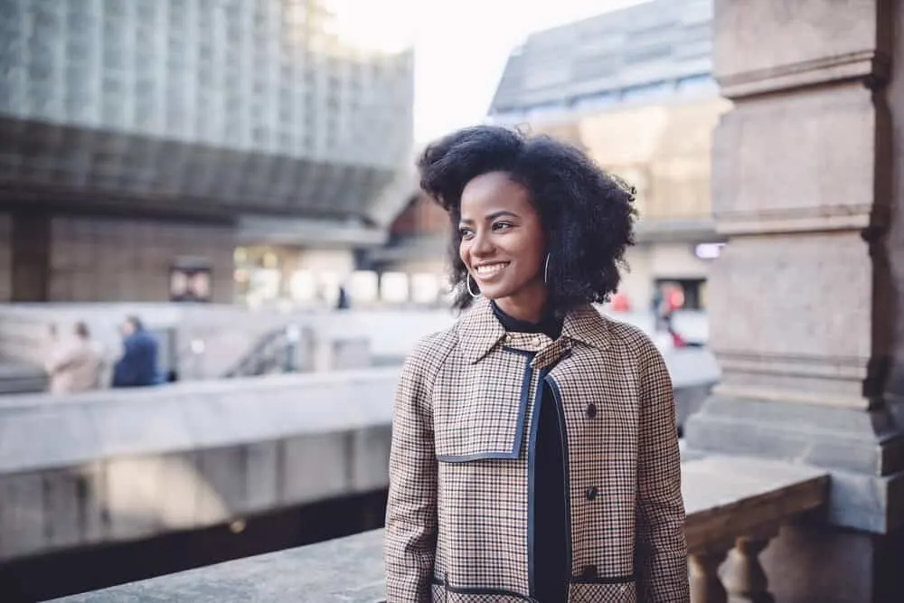 Black girl wearing a wash and go hairstyle that you can achieve if you wet curly hair everyday