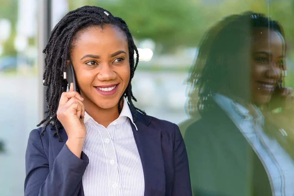 Black girl talking on the phone wearing teenage phase weak locs 