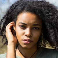 Cute black girl with naturally curly hair strands