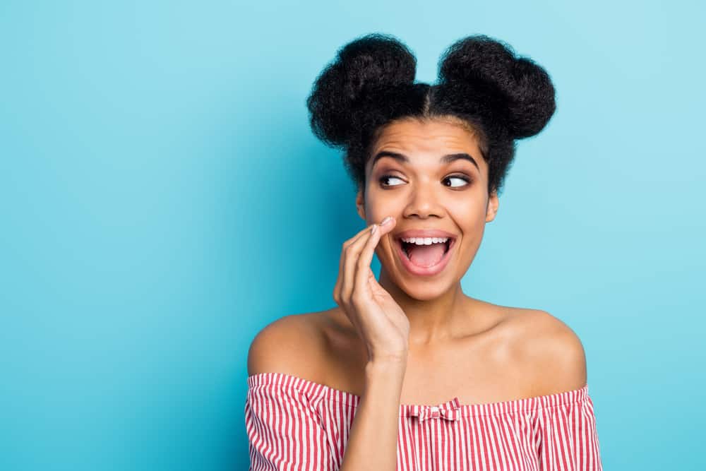 Black woman looking like Princess Leia with half down space buns with extra volume