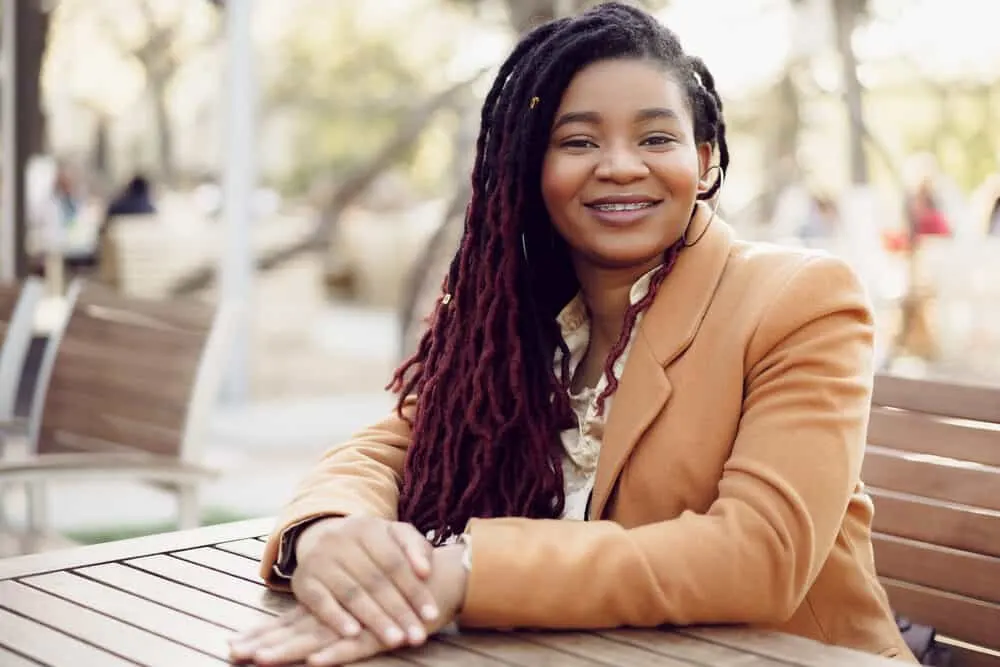 Cute black lady with braces wearing thinning locs on thick type 4 hair density