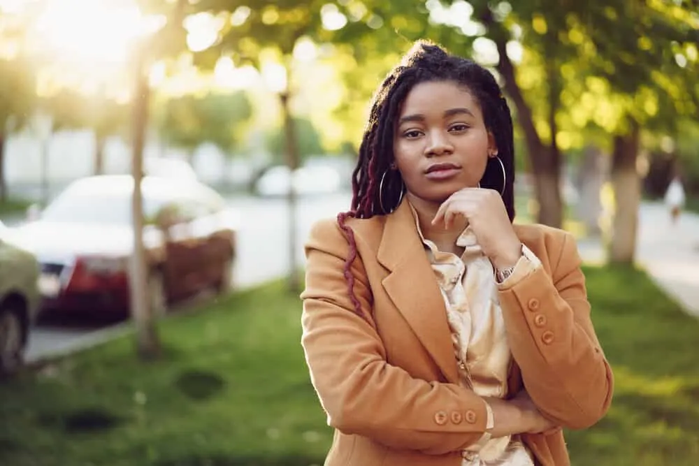 Black lady starting the locking process with her young dreadlocks 