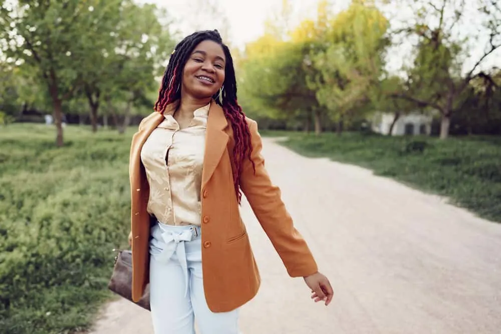 Stylish African American girl with loc extensions wearing smaller locs with red tips