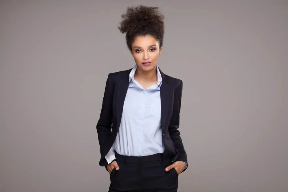 Black lady with polished look with shoulder-length hair in a curly hairstyle