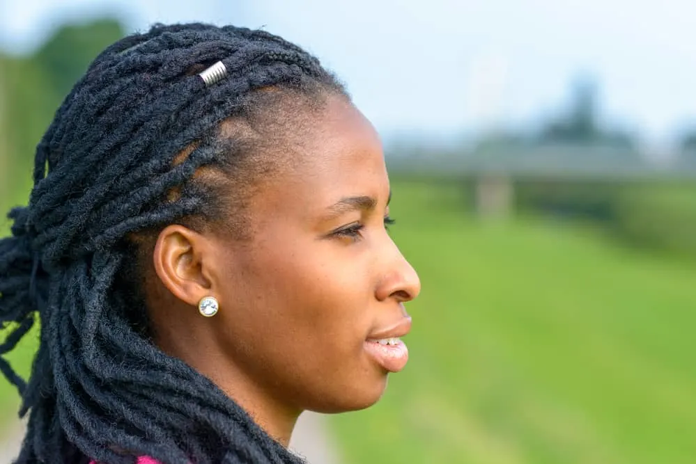 Young black girl with dreads that let her hair wet creating a breeding ground for mold