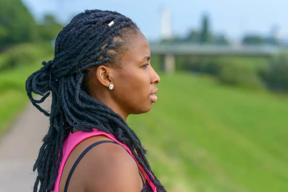 African American lady in a damp environment after rain that dreadlocks smell like a wet dog