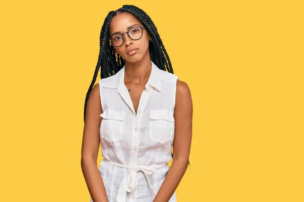 Black female with medium knotless braids that blend perfectly with her normal hair