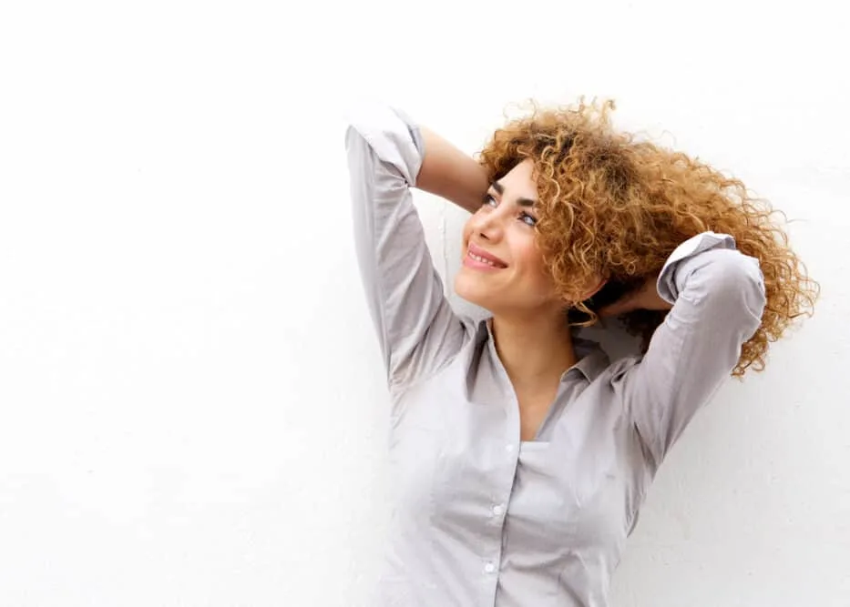 Beautiful lady with very fine hair showing off her curls after using a purple shampoo