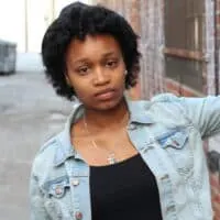 black women wearing a black derby hat