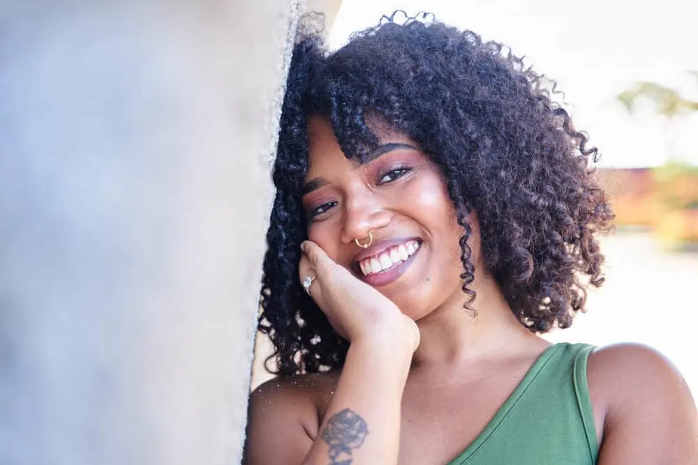 Beautiful Latina girl with Vaseline in her type 3b curly hair strands