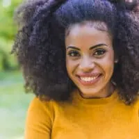 black girl with curly hair styled with coconut oil