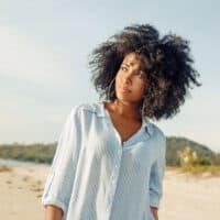 Beautiful African American female with long curly hair that uses Vicks vapor rub to grow hair