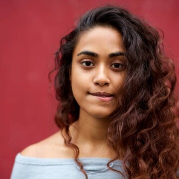 Young Indian woman with midnight shadows blue balayage hairstyle