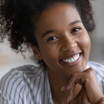 Pretty brown-skinned lady with curly hair and great smile