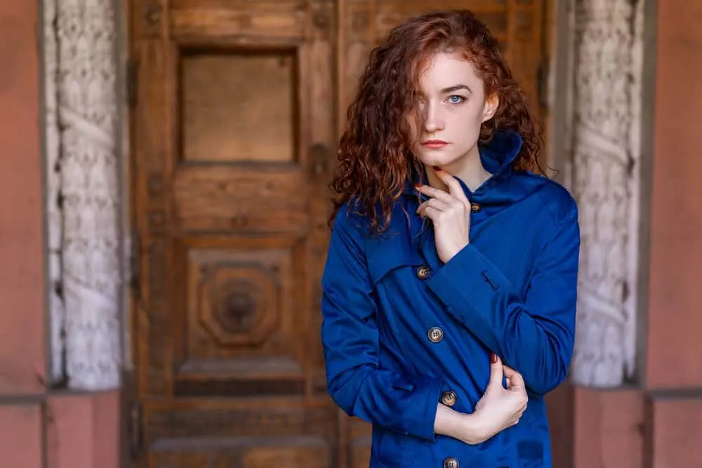 White lady with laid edges wearing a blue jacket a cool fall day