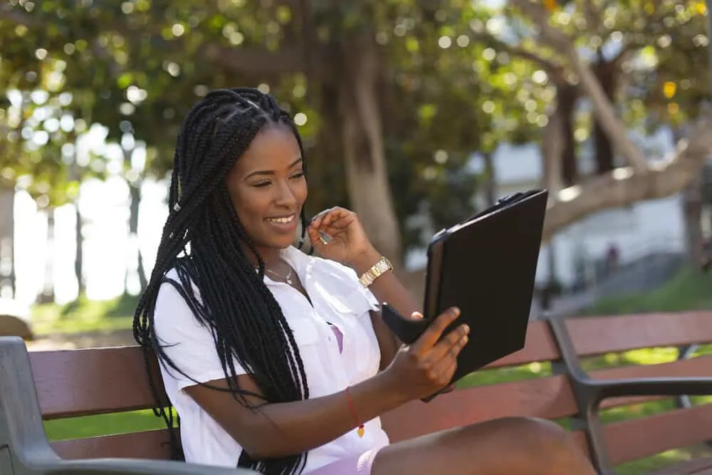 African American girl with braided hair extensions started by interweaving three strands