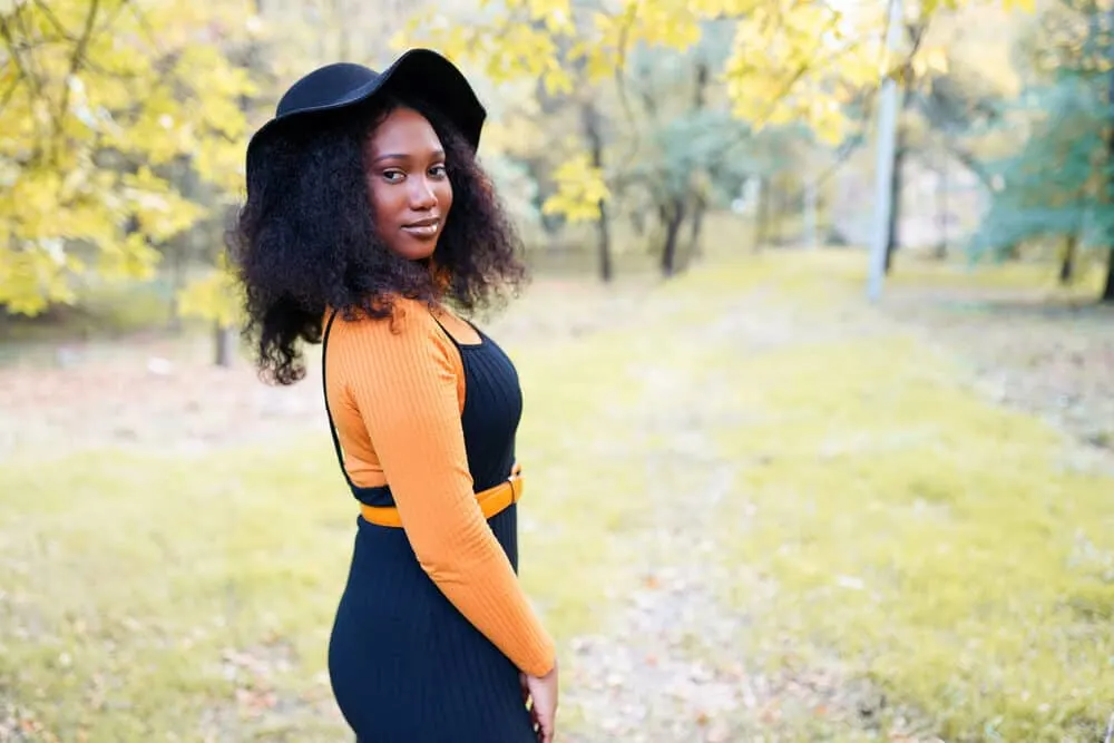 Beautiful African American lady with an oil-based pomade in her natural curls