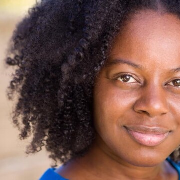 Confident black lady with kinky hair strands