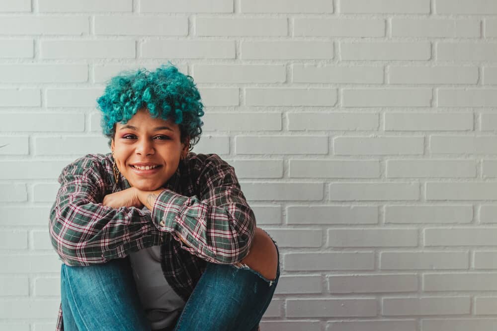 Young African woman with arctic fox denim-blue light hair wearing casual weekend clothes