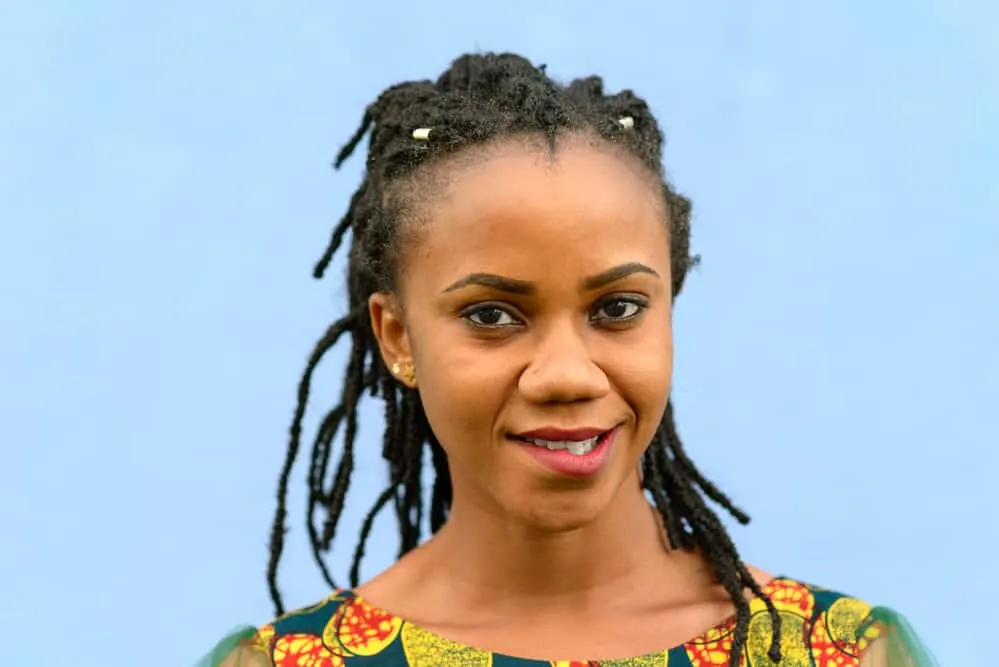 Young African woman with braided knotted hair preparing to start locs