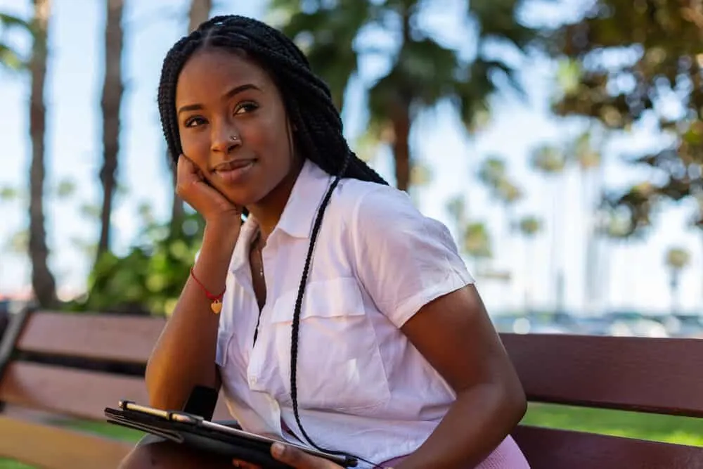 Beautiful black college girl with box braids, a fast hairstyle that's perfect for a college campus