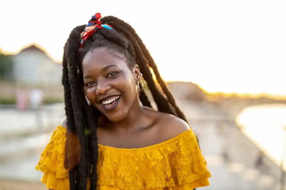 Lady with African hair wearing hoop earrings and dark red lipstick