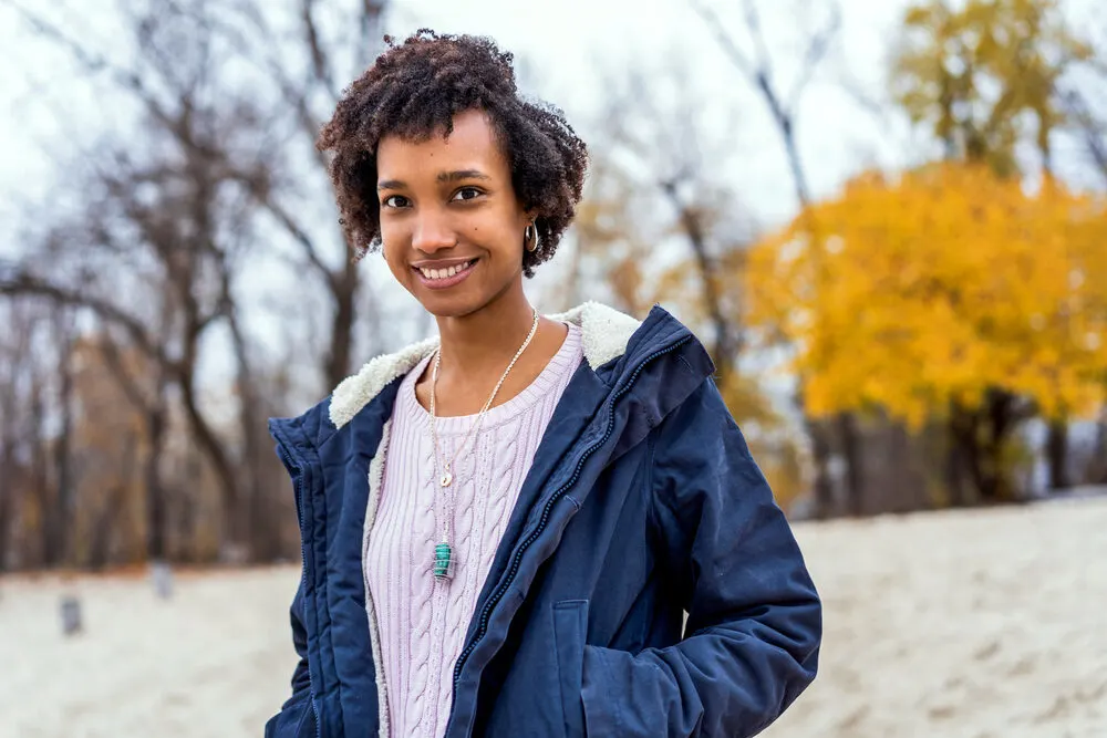 African American female with low porosity hair after leaving her hair stylist to define her curl pattern.