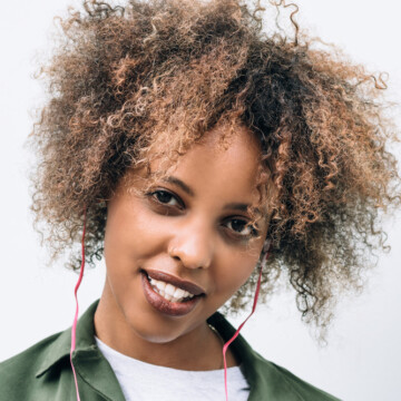 Cute black girl with 3C hair wearing a wash n go - a popular trend for curly hair girls.