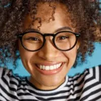 Joyful multiethnic female with red-dyed hair with Jell-O dip dye.